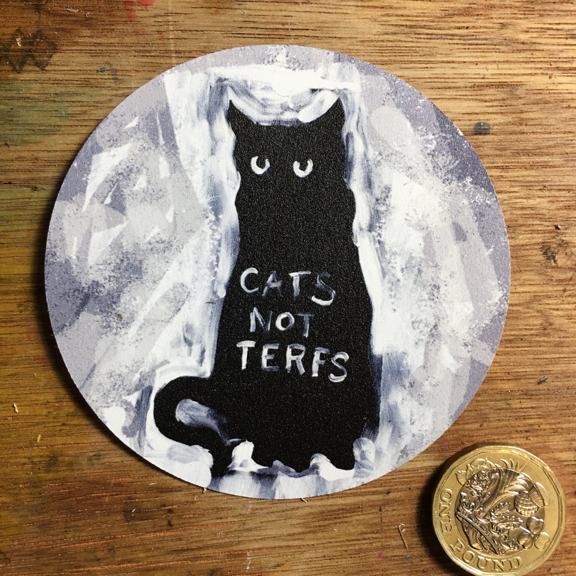 round sticker with black cat image. On the black cat it is written CATS NOT TERFS.